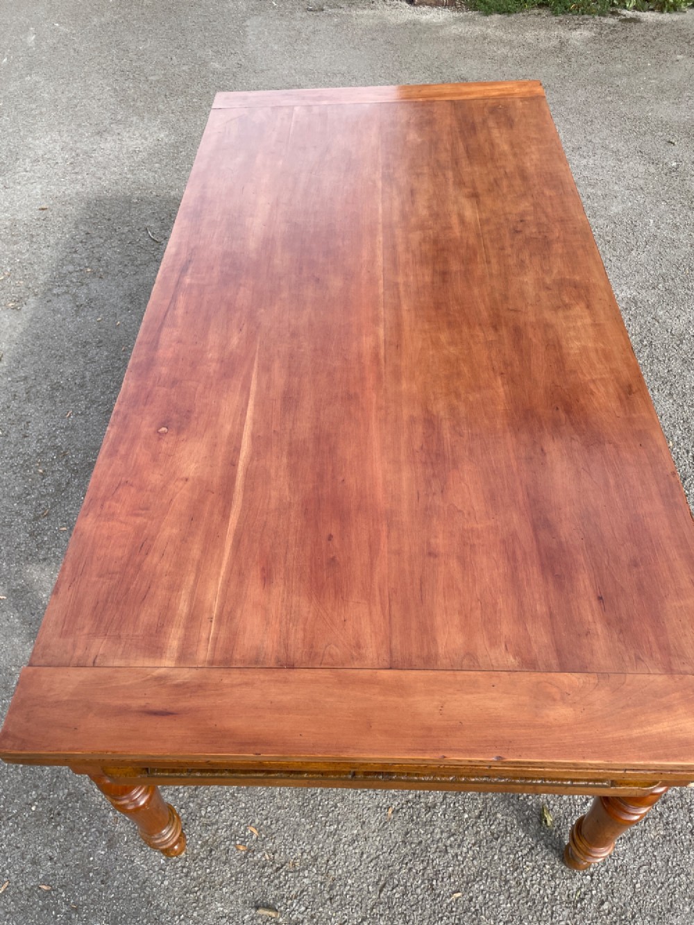 A 19th-century French cherrywood extending dining table featuring turned legs and a polished rectangular top. View XII