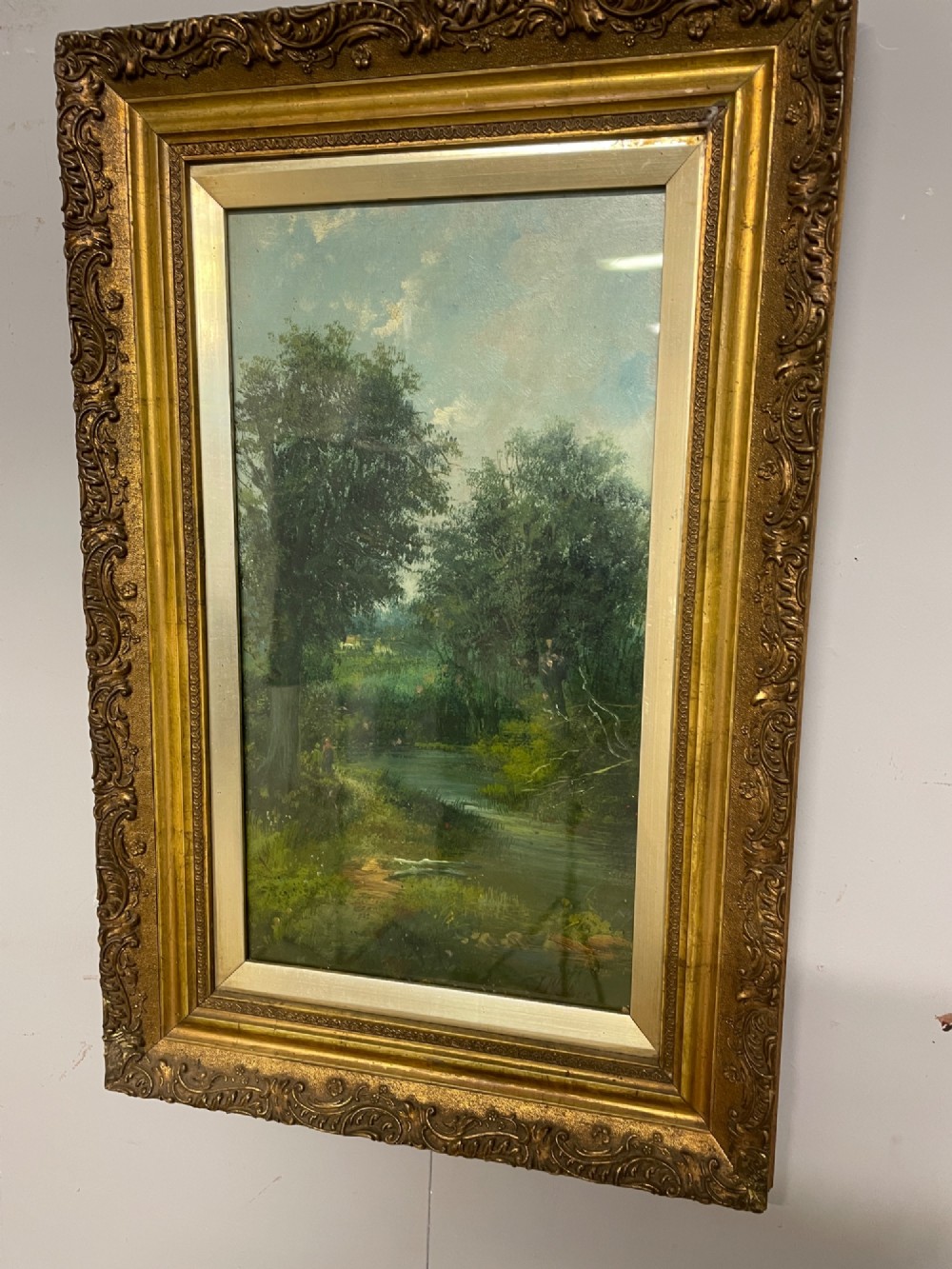 A pair of vertical late 19th-century oil paintings depicting green river and woodland landscapes in ornate gilded frames. View III