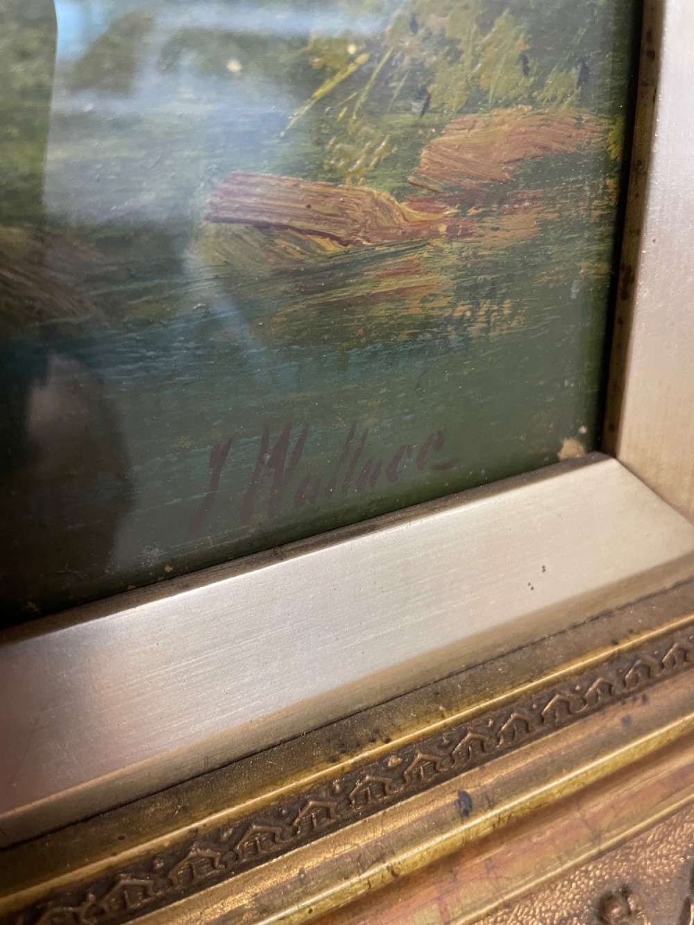 A pair of vertical late 19th-century oil paintings depicting green river and woodland landscapes in ornate gilded frames. View V