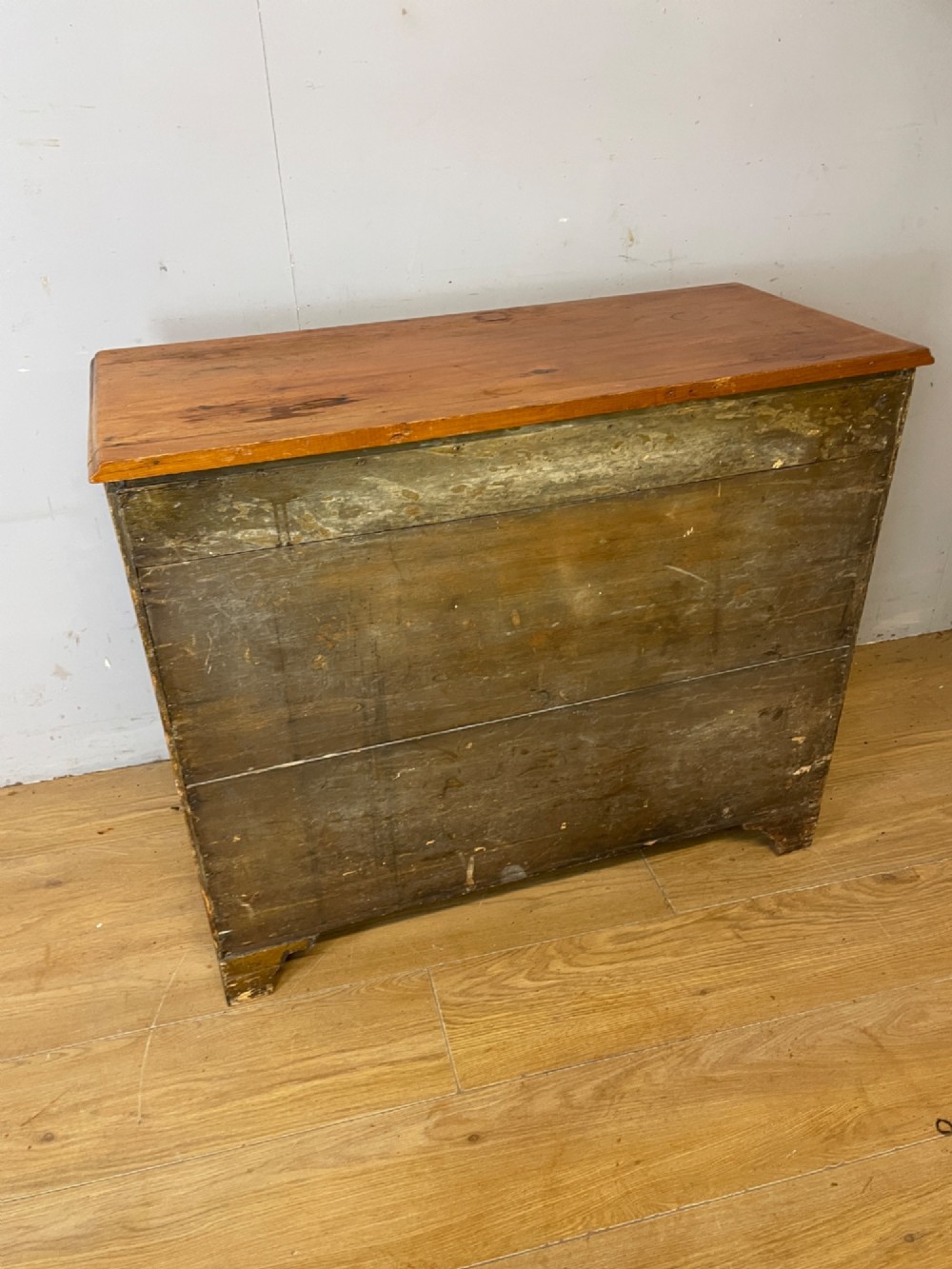 A nineteenth-century pine chest of drawers featuring three full-width drawers with turned wooden handles and bracket feet. View VIII