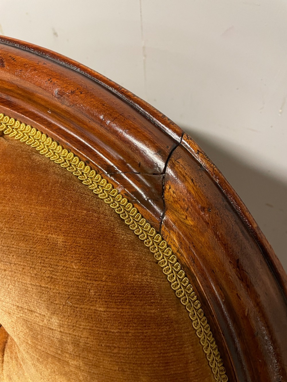 Victorian mahogany tub armchair upholstered in button-tufted amber velvet with curved front legs on brass castors. View XII