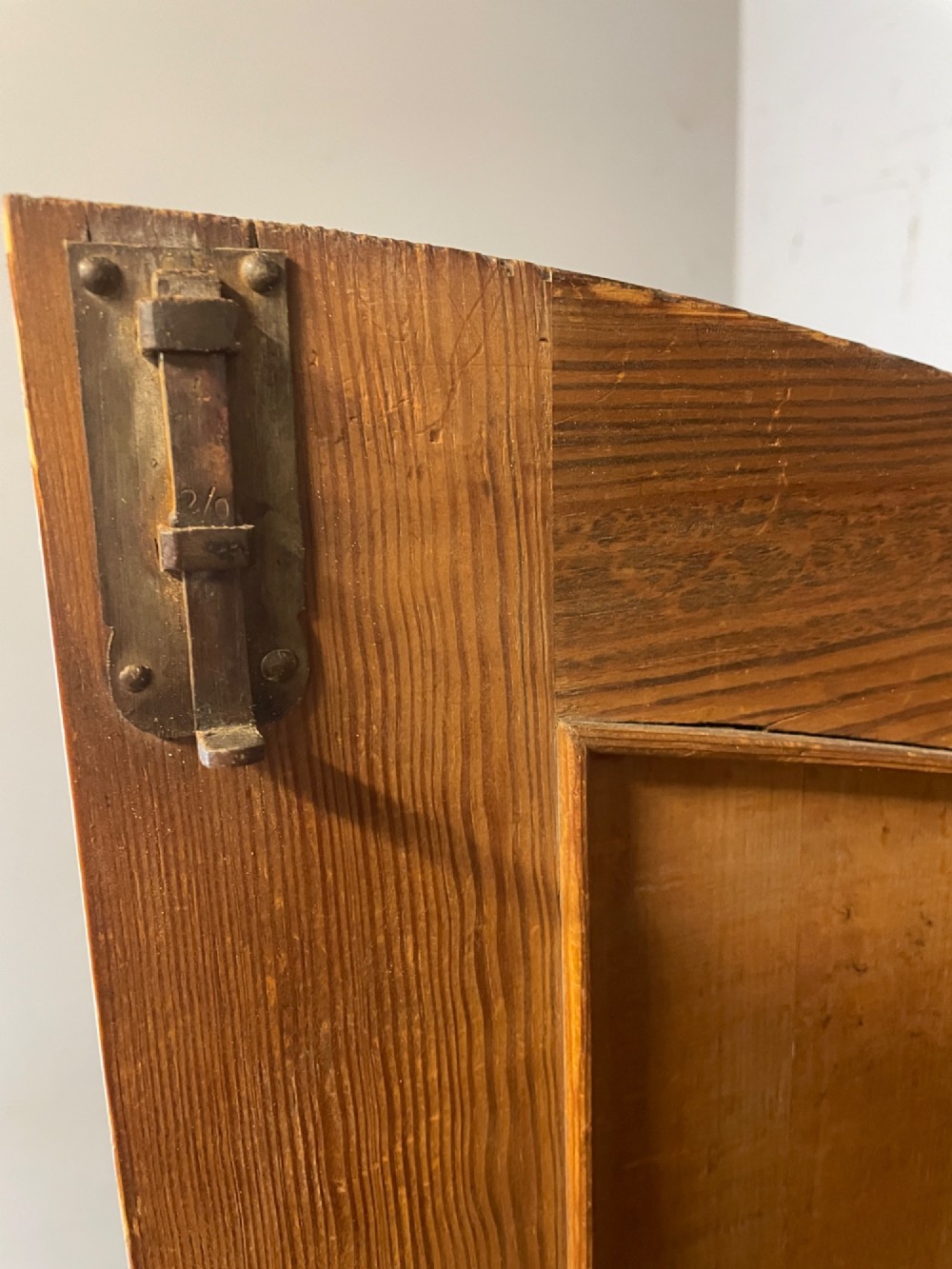 A nineteenth-century French figured walnut two-door armoire featuring an arched cornice with turned corner finials and a central circular moulding. View VI