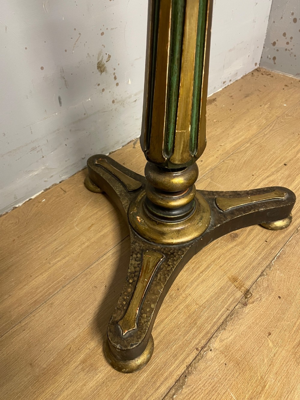 A 19th-century gilt and ebonised torchere stand featuring a circular needlework top, a turned column stem, and tripod feet. View VIII