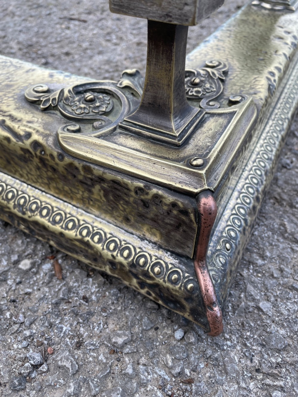 A 19th-century brass fireplace fender featuring a twisted top rail supported by four square columns over an embossed base. View VIII