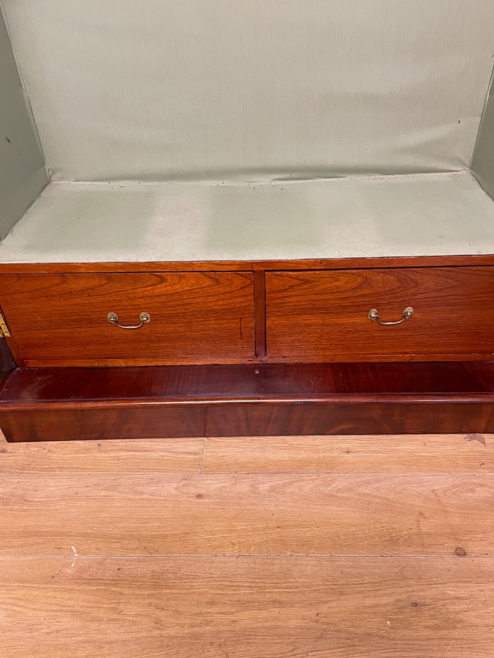 A 19th-century double wardrobe constructed from flame mahogany featuring two arched panelled doors, carved corbel accents, a moulded cornice, and a flat plinth base. View VIII