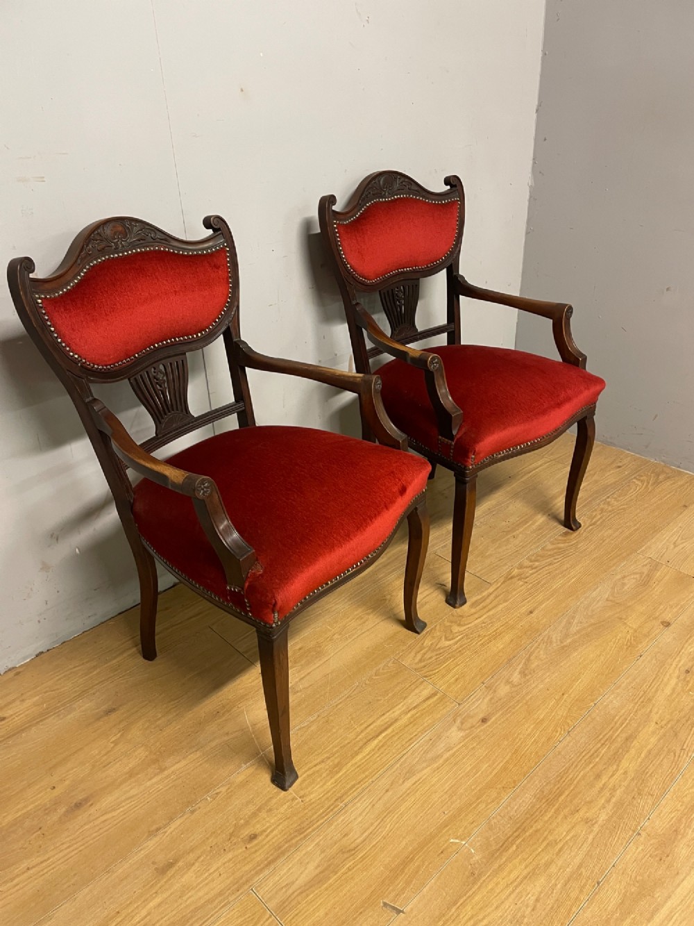 A pair of nineteenth-century Empire style mahogany armchairs upholstered in deep red velvet with decorative stud trimming. View III