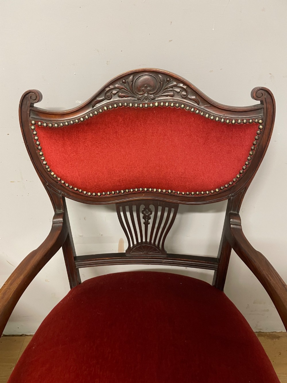 A pair of nineteenth-century Empire style mahogany armchairs upholstered in deep red velvet with decorative stud trimming. View IV