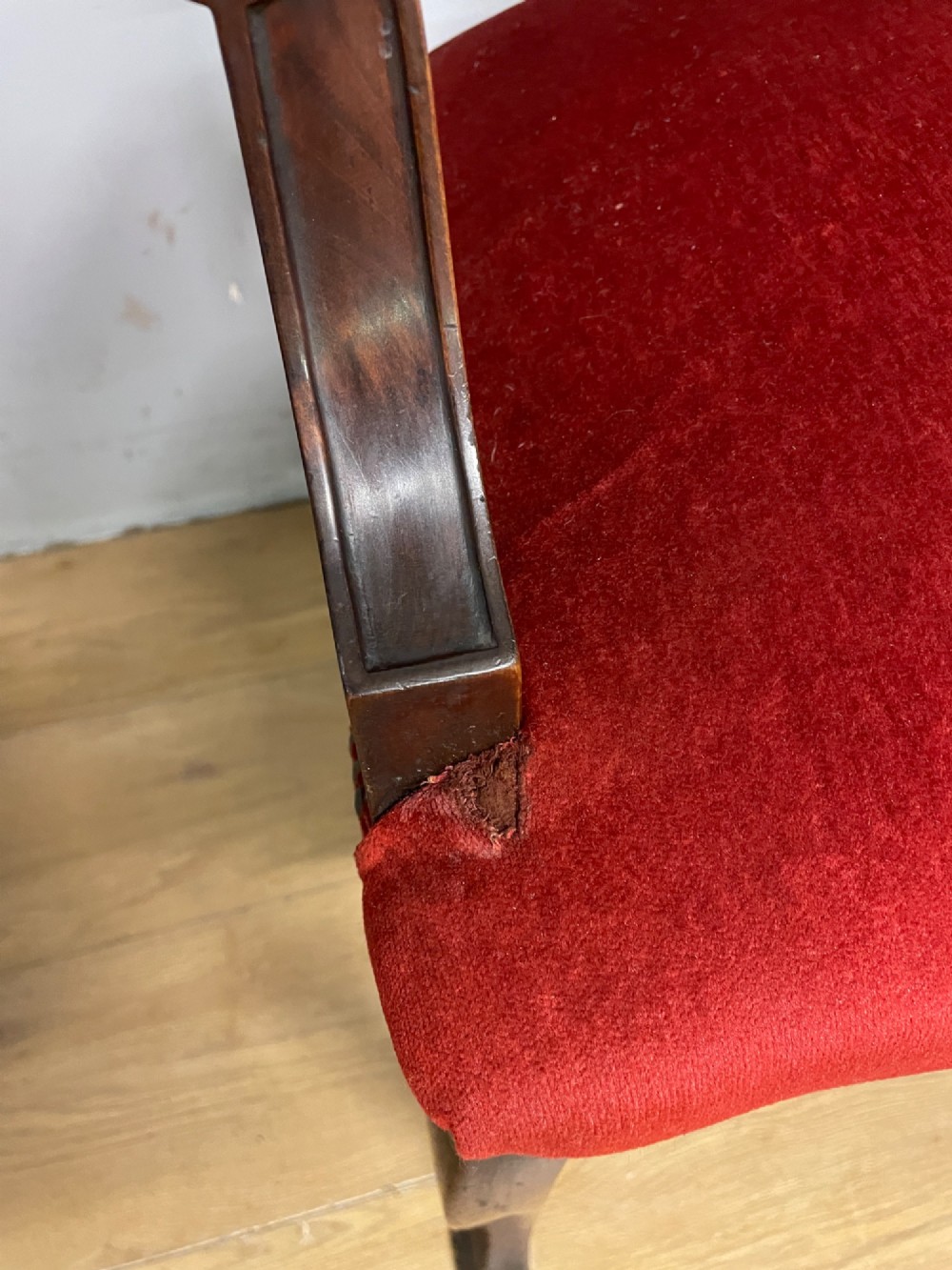 A pair of nineteenth-century Empire style mahogany armchairs upholstered in deep red velvet with decorative stud trimming. View VII