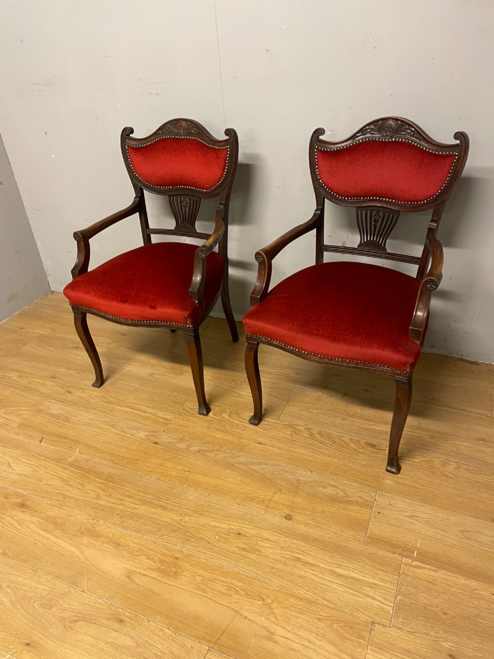 A pair of nineteenth-century Empire style mahogany armchairs upholstered in deep red velvet with decorative stud trimming. View VIII