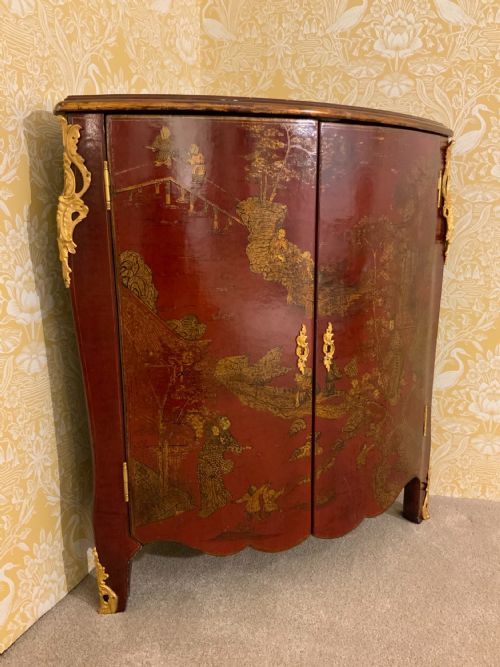 a red lacquered chinoiserie corner cabinet - CATEGORY: ANTIQUE CUPBOARDS - DATED 1900