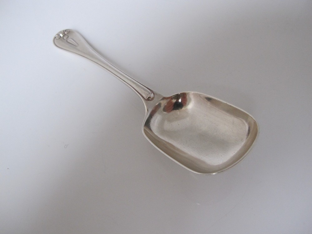 A Victorian sterling silver jam spoon featuring a shovel-shaped rectangular bowl and a decorated Hanoverian pattern handle with scroll terminal. View III