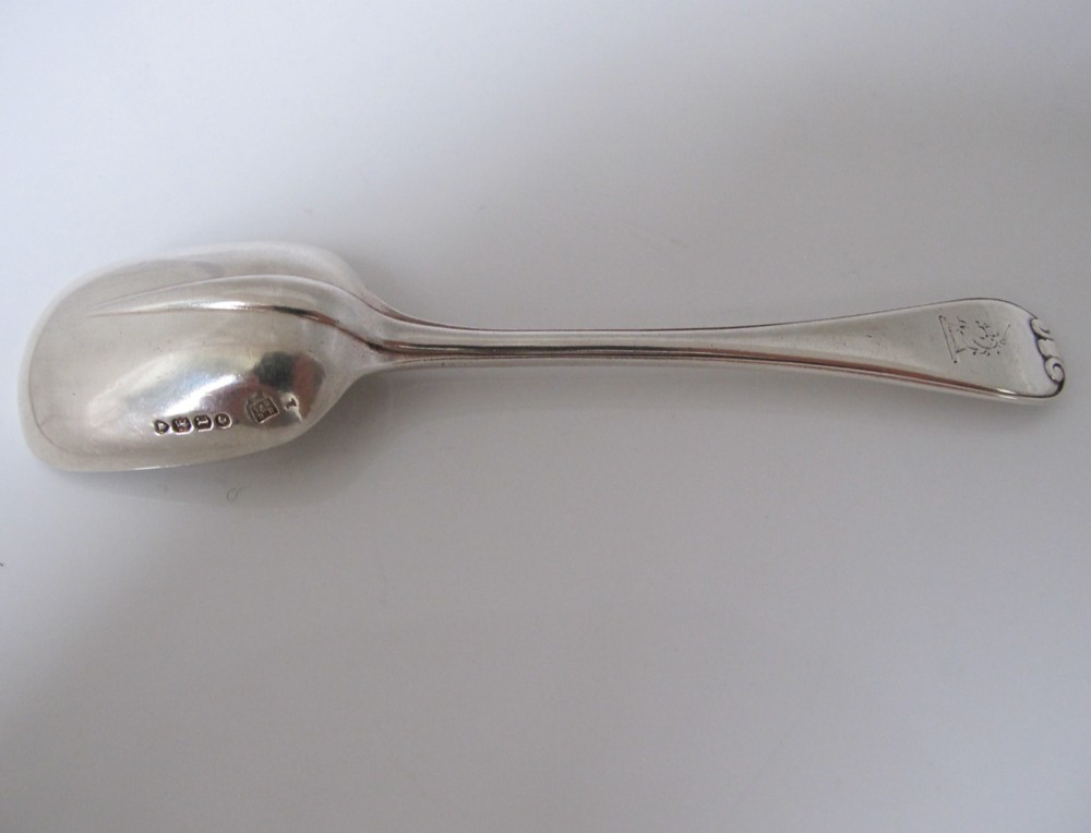 A Victorian sterling silver jam spoon featuring a shovel-shaped rectangular bowl and a decorated Hanoverian pattern handle with scroll terminal. View IV