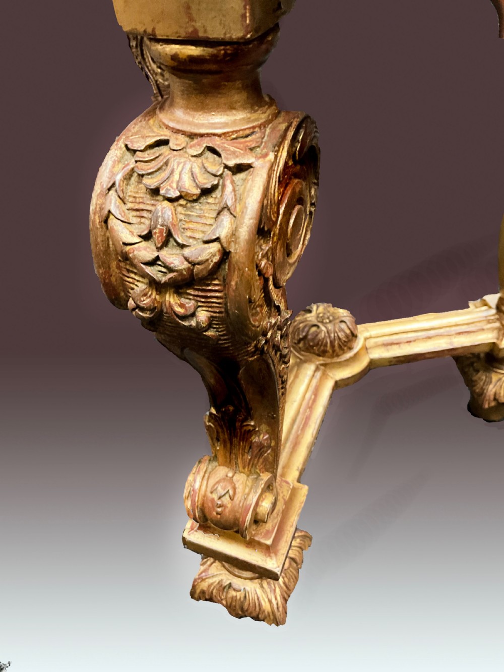 A late nineteenth-century circular giltwood urn stand featuring carved scroll legs, an X-form stretcher, and a dished circular top. View II