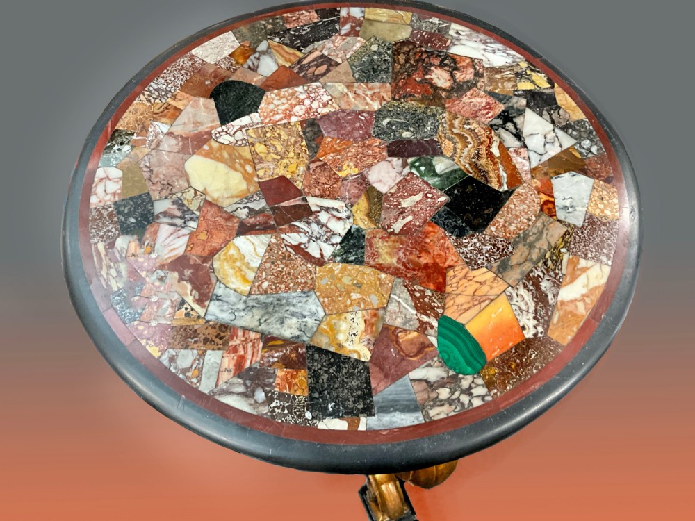A circular Victorian specimen table featuring a colourful inlaid marble mosaic top on curved giltwood legs. View III
