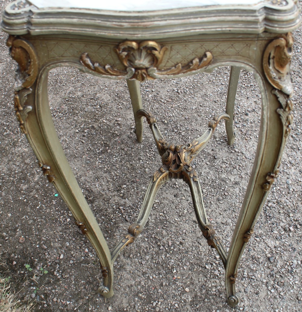 A Louis XV style side table featuring a white and grey veined marble top resting on a painted frame with gilded shell motifs and cabriole legs. View IV