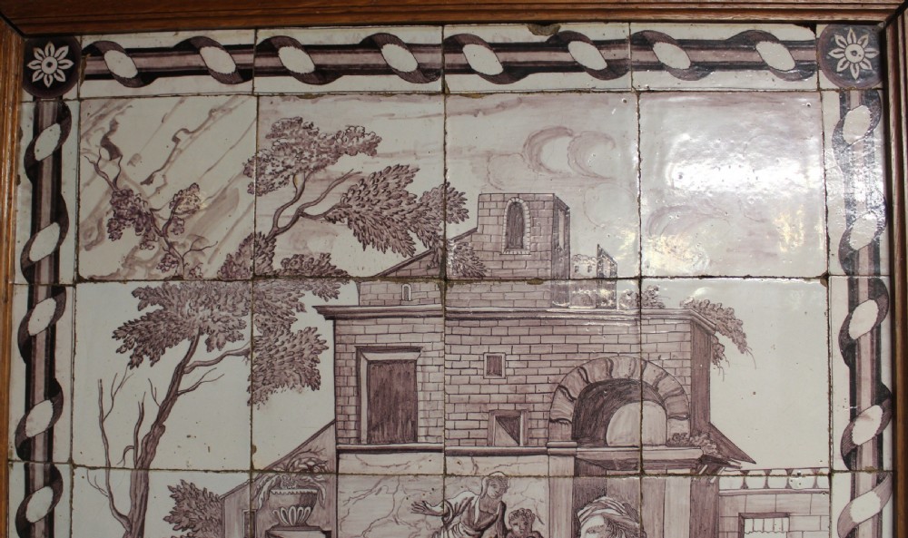 A framed multi-tile ceramic panel hand-painted in manganese monochrome tones featuring a classical scene with figures in front of architectural ruins. View II