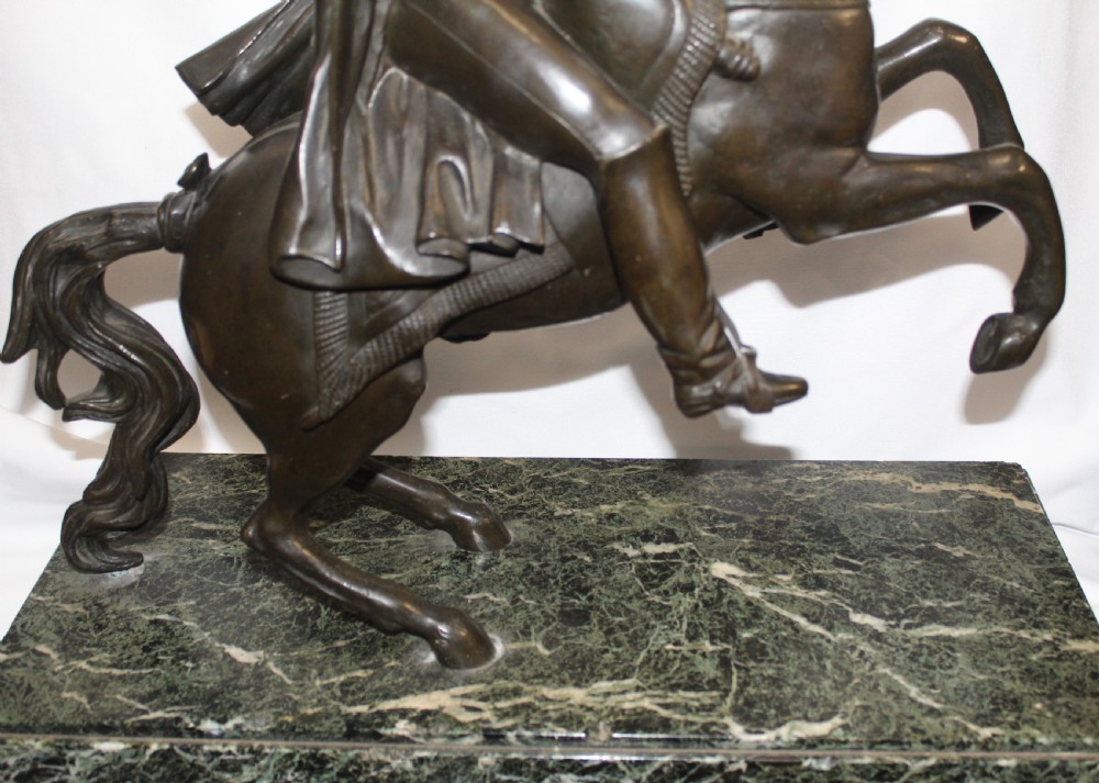 A patinated bronze sculpture depicting Napoleon Bonaparte riding a rearing horse, mounted on a polished green marble rectangular base. View III