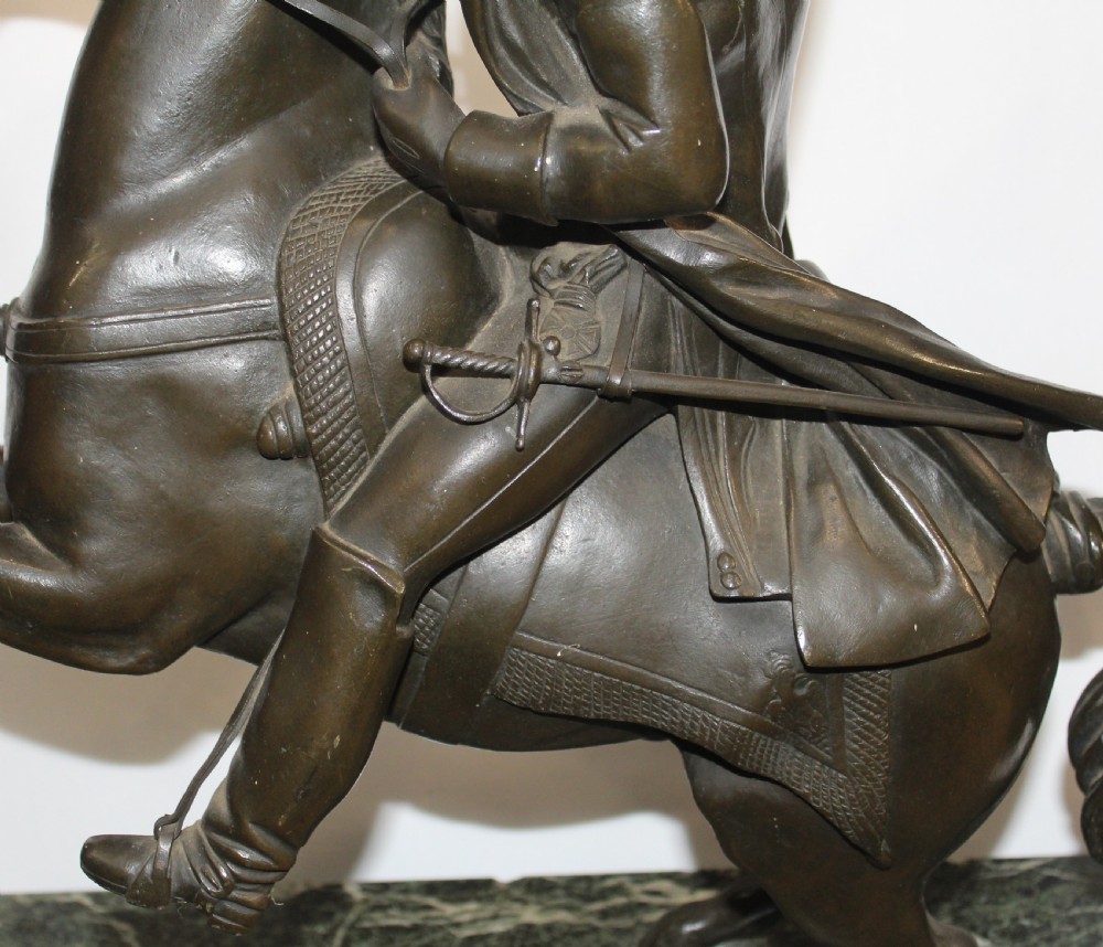 A patinated bronze sculpture depicting Napoleon Bonaparte riding a rearing horse, mounted on a polished green marble rectangular base. View V