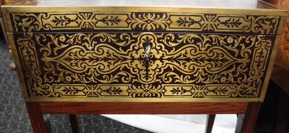 An antique brass and tortoiseshell Boulle work writing box mounted on a dark rosewood stand with tapered square legs. View VI