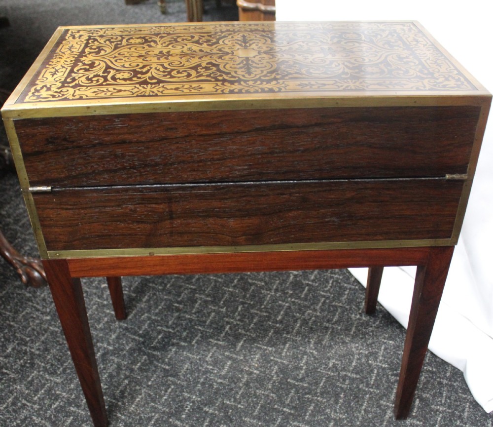 An antique brass and tortoiseshell Boulle work writing box mounted on a dark rosewood stand with tapered square legs. View VIII