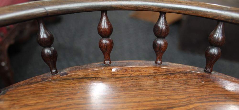 A dark rosewood circular wine table featuring a spindled gallery rim, a turned column stem, and a carved lobed base. View III