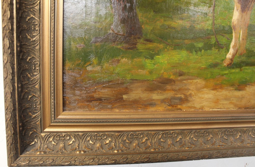 An oil painting on canvas depicting a brown and white calf standing in a green field surrounded by trees, housed within an ornate gilded frame. View V