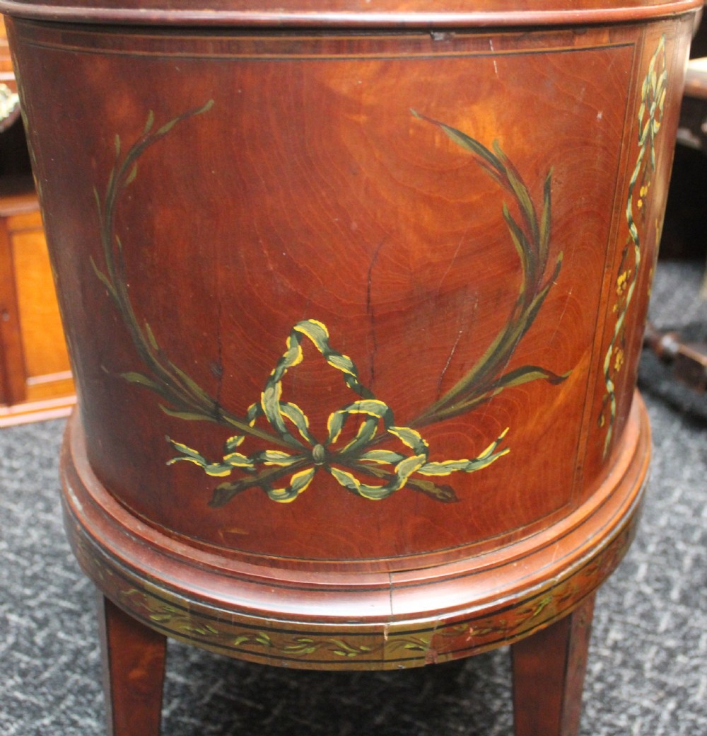 An oval antique satinwood wine cooler featuring hand-painted figurative scenes and floral garlands supported by tapered legs. View III