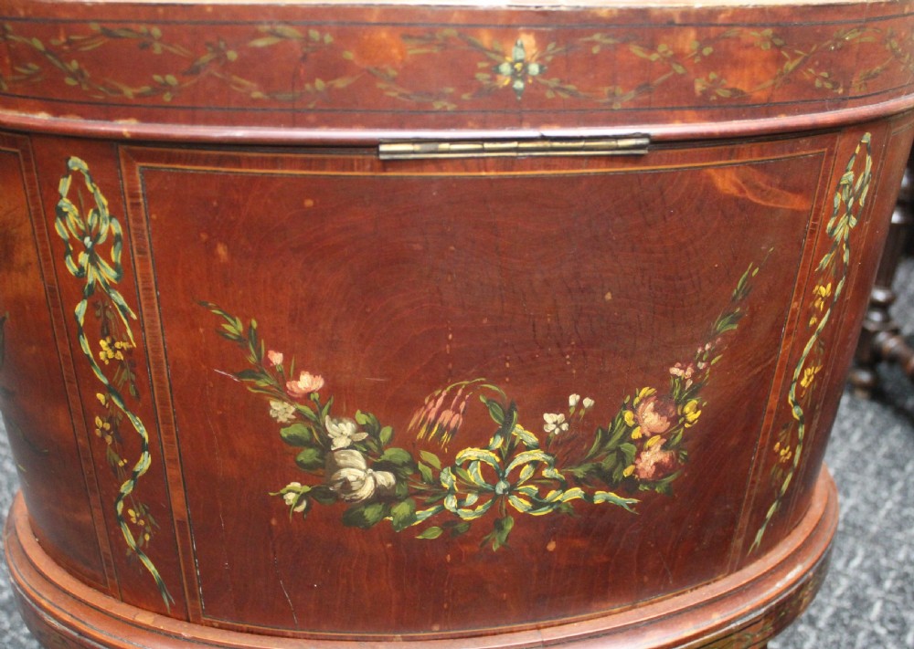 An oval antique satinwood wine cooler featuring hand-painted figurative scenes and floral garlands supported by tapered legs. View IV