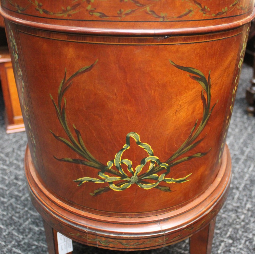 An oval antique satinwood wine cooler featuring hand-painted figurative scenes and floral garlands supported by tapered legs. View V