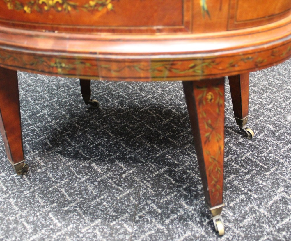 An oval antique satinwood wine cooler featuring hand-painted figurative scenes and floral garlands supported by tapered legs. View VI