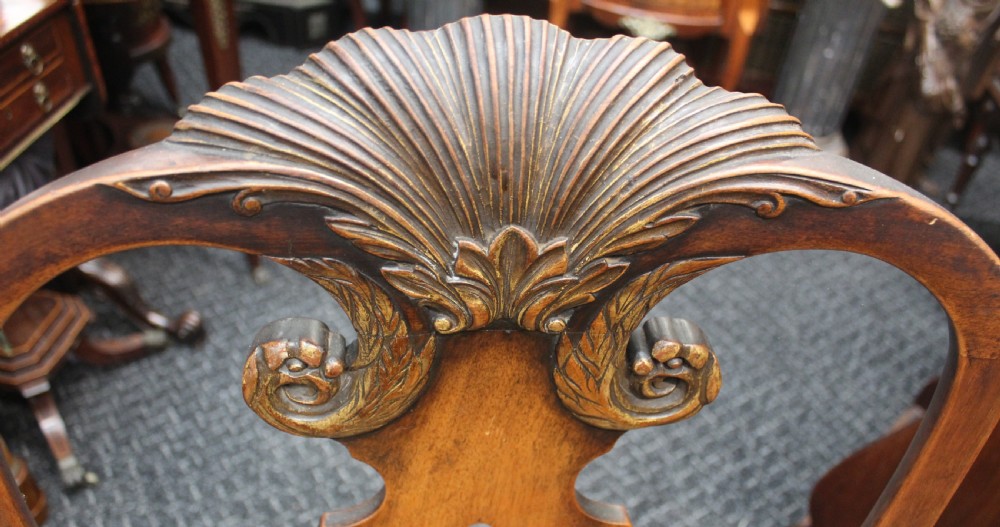 An antique Chippendale style carved mahogany open armchair with a shell crest, pierced splat back, carved cabriole legs, and an aged green leather drop-in seat pad. View II