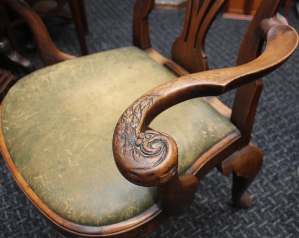 An antique Chippendale style carved mahogany open armchair with a shell crest, pierced splat back, carved cabriole legs, and an aged green leather drop-in seat pad. View III