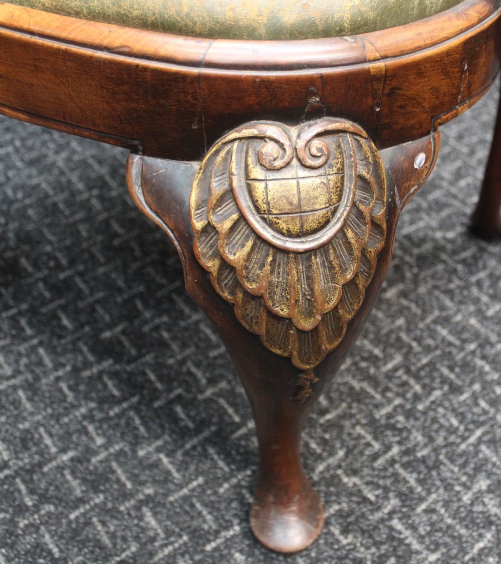 An antique Chippendale style carved mahogany open armchair with a shell crest, pierced splat back, carved cabriole legs, and an aged green leather drop-in seat pad. View IV