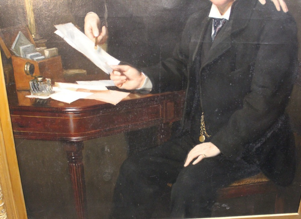 A large antique oil painting depicting two gentlemen in dark suits examining documents near a desk, set in an ornate gilded frame. View VIII