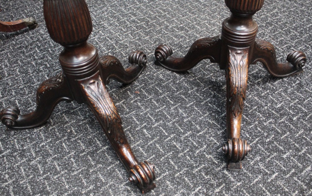 A pair of tall dark mahogany torchere stands featuring octagonal gallery tops, fluted stems, and carved tripod scroll legs. View IV