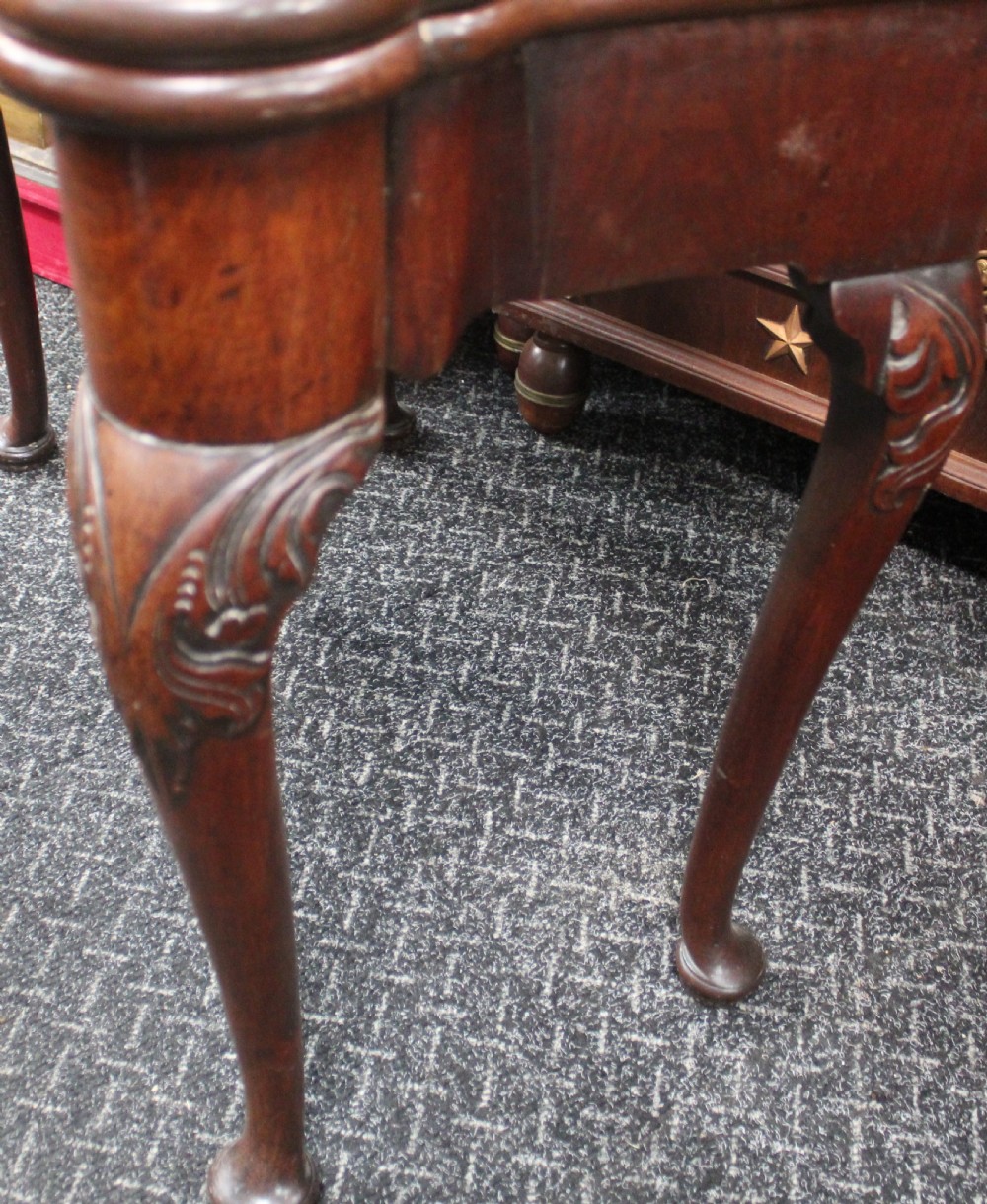 An antique mahogany fold-over games table featuring carved cabriole legs with pad feet and a shaped serpentine top. View III