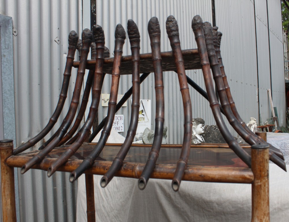 A Victorian bamboo shelving unit featuring a pagoda canopy top, open display tiers, and a small lacquered lower cabinet. View II