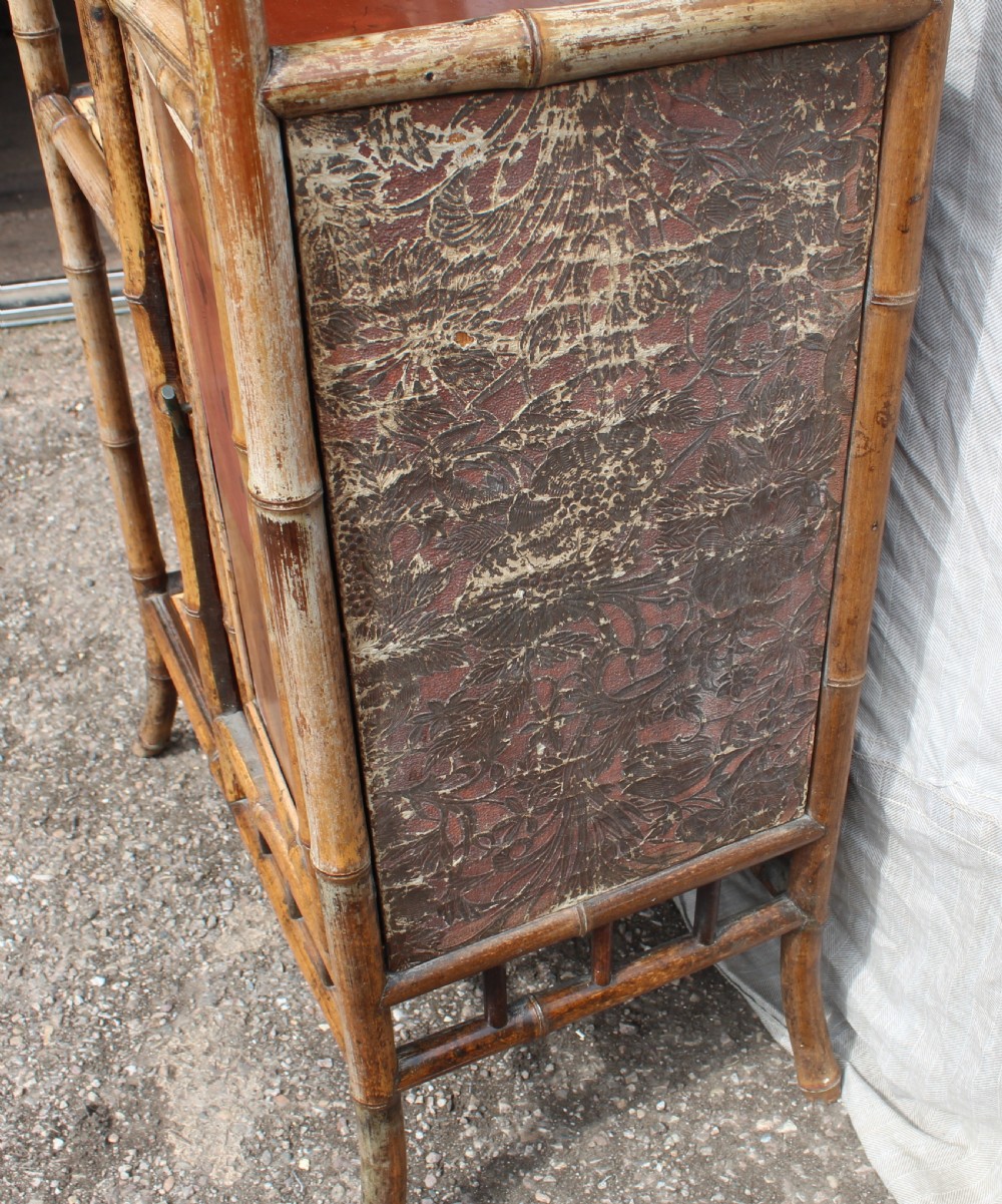 A Victorian bamboo shelving unit featuring a pagoda canopy top, open display tiers, and a small lacquered lower cabinet. View IV