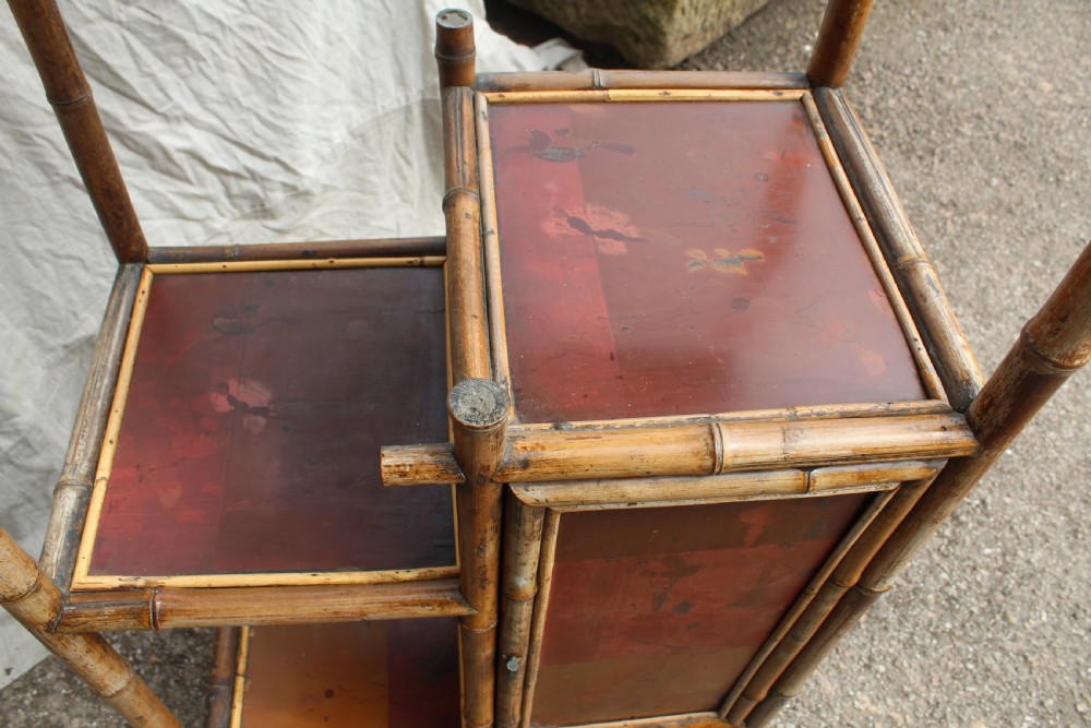A Victorian bamboo shelving unit featuring a pagoda canopy top, open display tiers, and a small lacquered lower cabinet. View VII