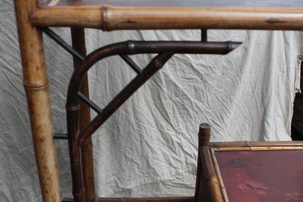 A Victorian bamboo shelving unit featuring a pagoda canopy top, open display tiers, and a small lacquered lower cabinet. View VIII