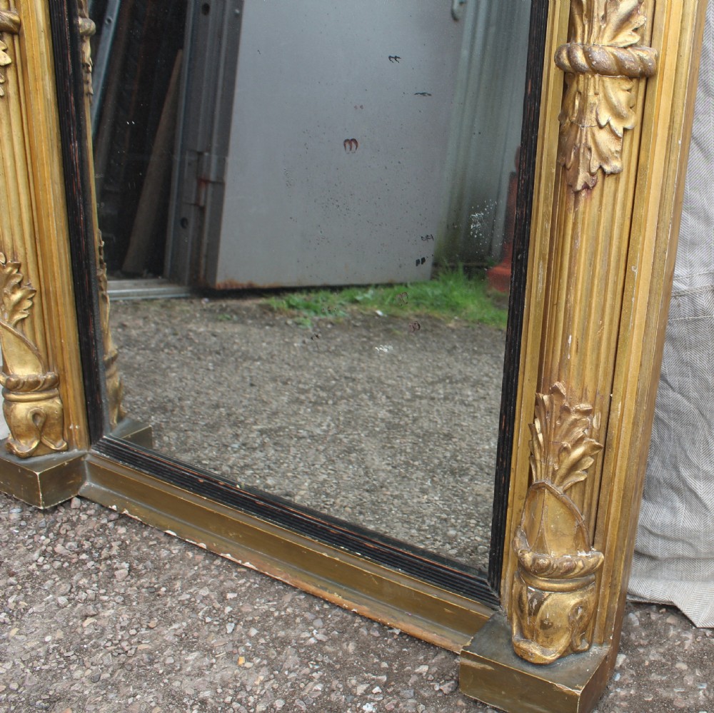 A rectangular antique giltwood pier mirror with fluted side columns, rosette medallions, and a stepped breakfront cornice. View III