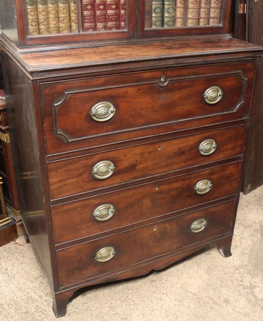 A dark mahogany Georgian secretaire bookcase featuring glazed upper doors with astragal tracery above a chest of four drawers with brass oval handles. View III