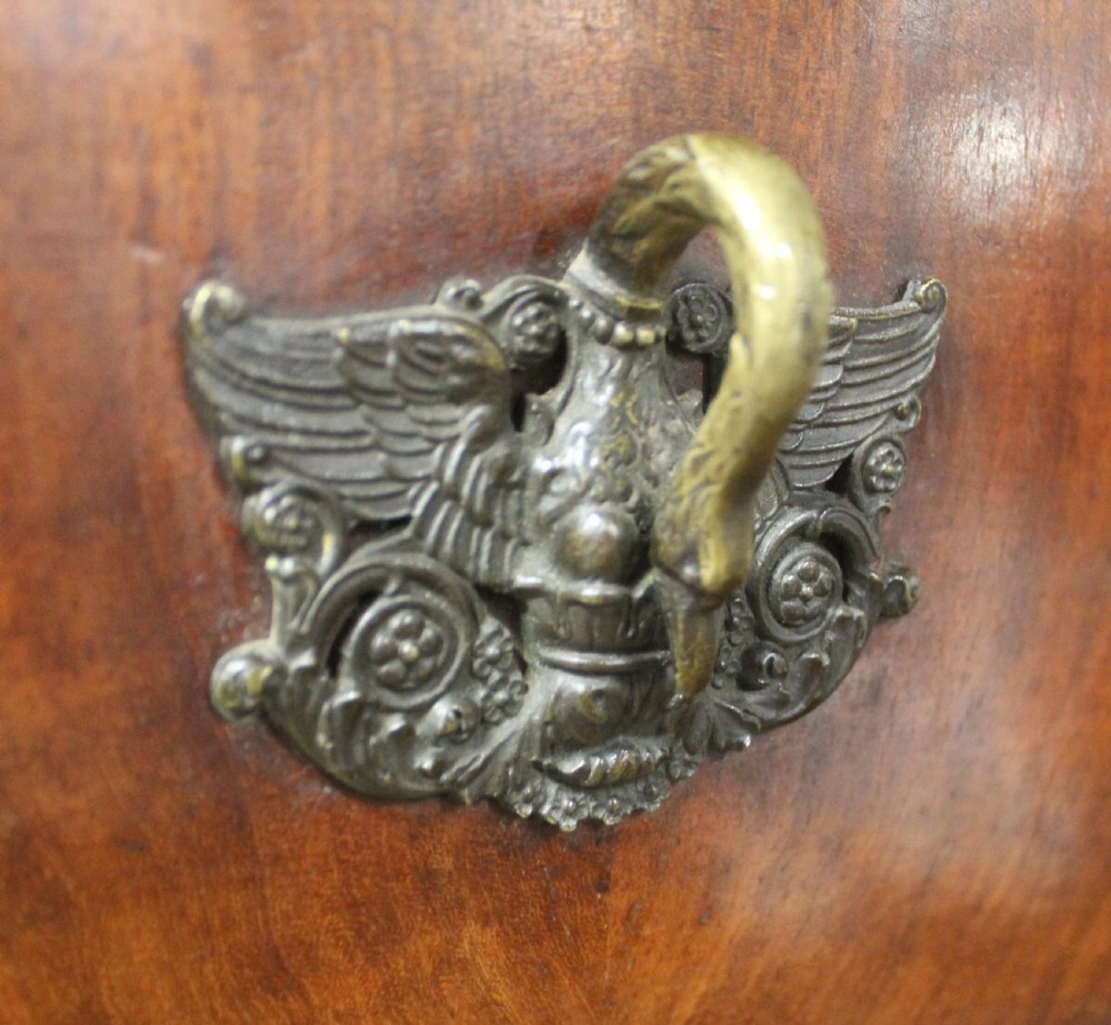 A tall 19th-century French flame mahogany semainier chest of drawers with a fitted grey marble top and ornamental brass handles. View VII