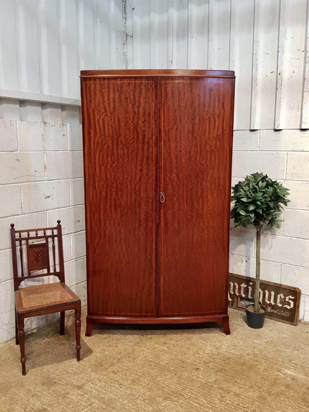 ANTIQUE BOW FRONT FIGURED MAHOGANY DOUBLE WARDROBE C1920