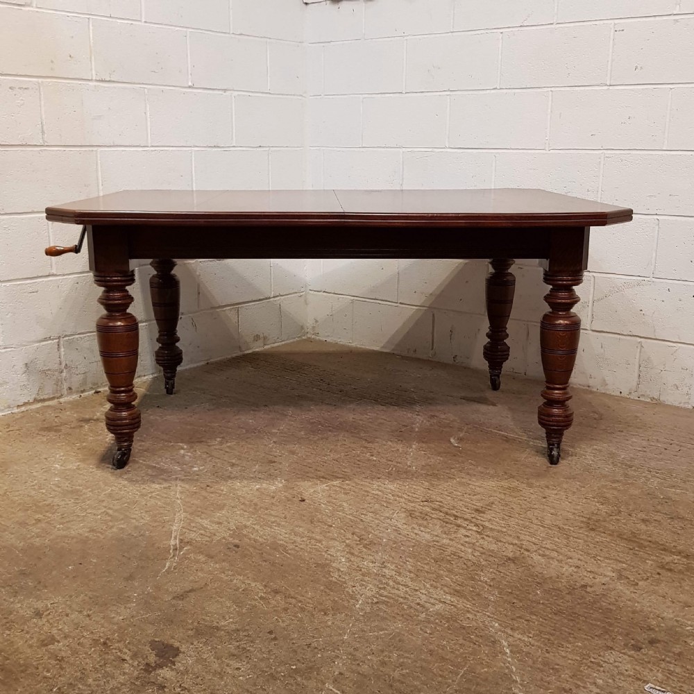 ANTIQUE VICTORIAN OAK EXTNDING DINING TABLE SEATS UP TO TWELVE. C1880 View V