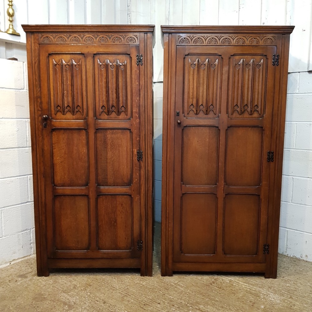 ANTIQUE PAIR OF CARVED JOINED OAK SINGLE WARDROBES BY DENBY & SPINKS C1920