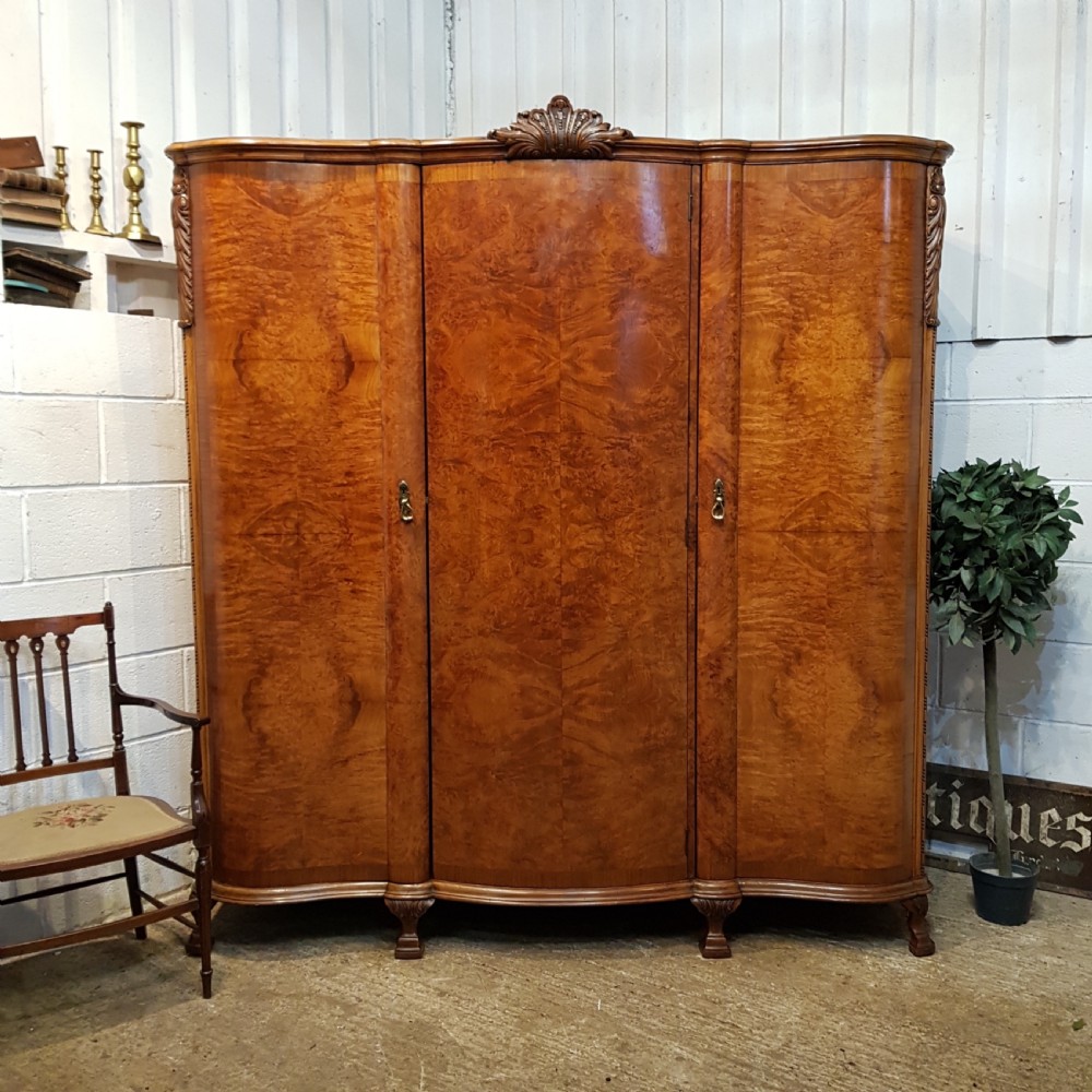ANTIQUE BURR WALNUT SERPENTINE SHAPED TRIPLE WARDROBE C1920