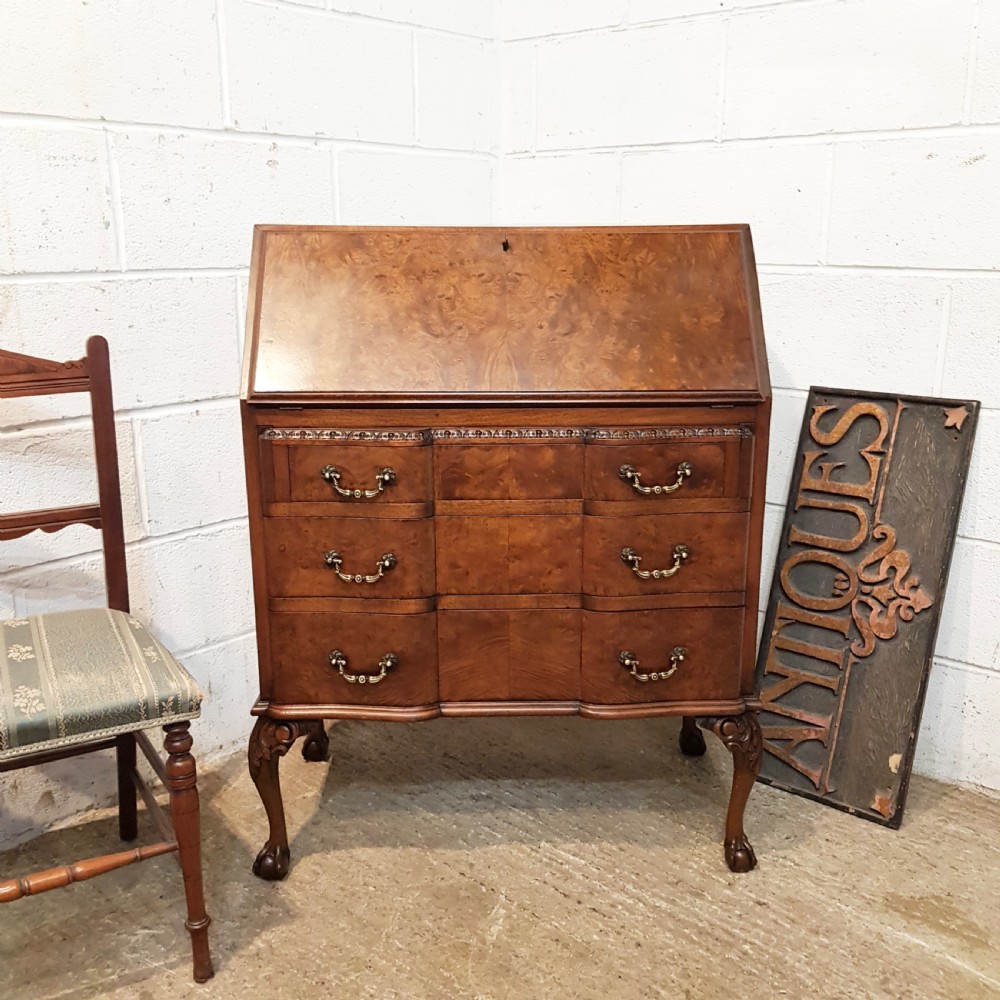 ANTIQUE BURR WALNUT SERPENTINE SHAPED BUREAU BY MAPLES & CO. C1920