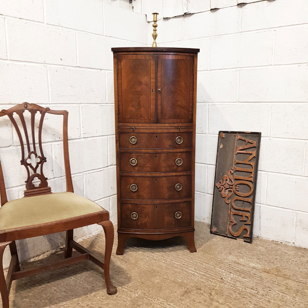 ANTIQUE GENTS MAHOGANY BOW FRONT TALL BOY WITH BRUSHING SLIDE C1920