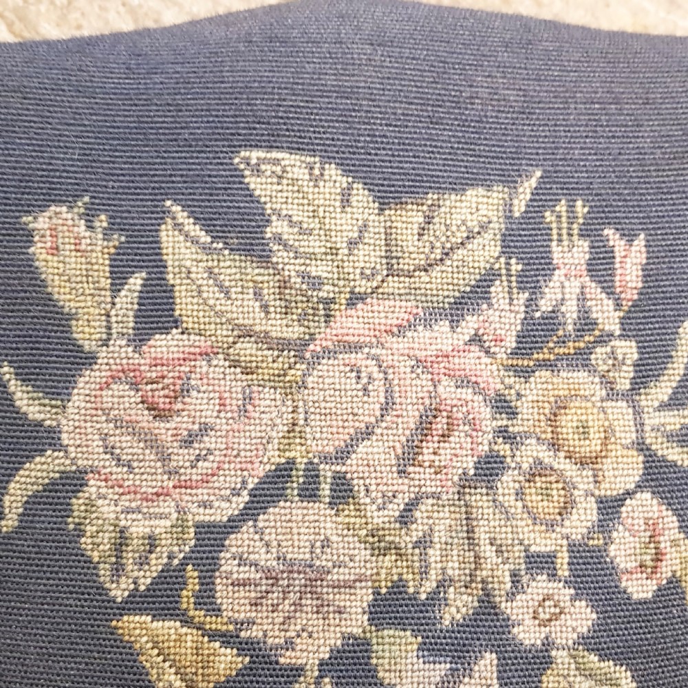 An antique Victorian carved oak hall chair featuring dark blue tapestry upholstery with floral embroidery and an openwork carved scrollwork frame. View V